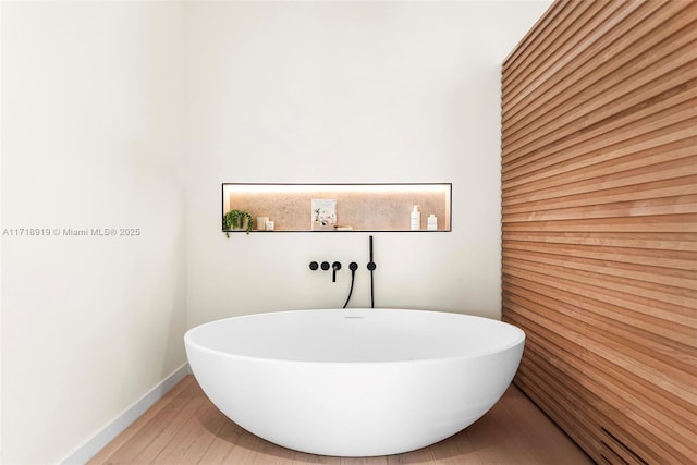 bathroom featuring hardwood / wood-style flooring and a bathing tub