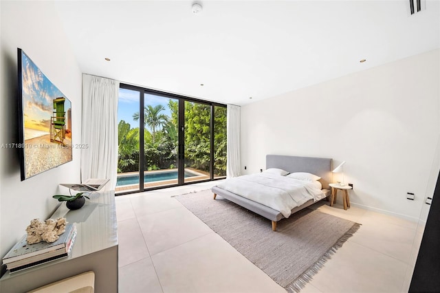 bedroom with access to exterior and a wall of windows