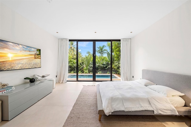 bedroom featuring access to exterior and a wall of windows