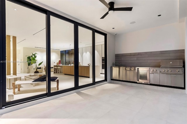 interior space with a grill, ceiling fan, and an outdoor kitchen