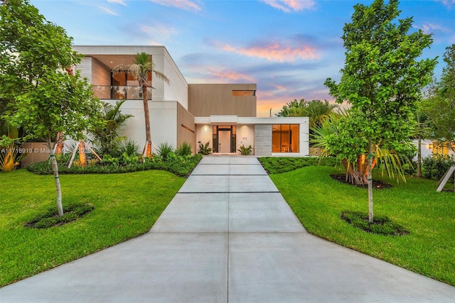 contemporary home featuring a lawn