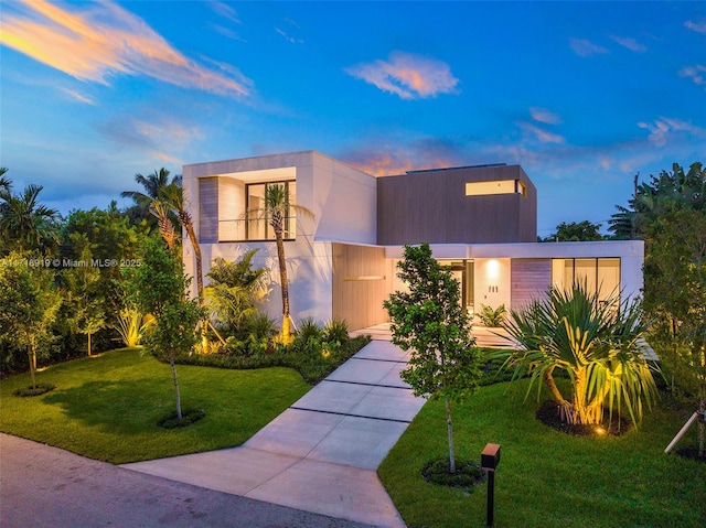 modern home featuring a yard