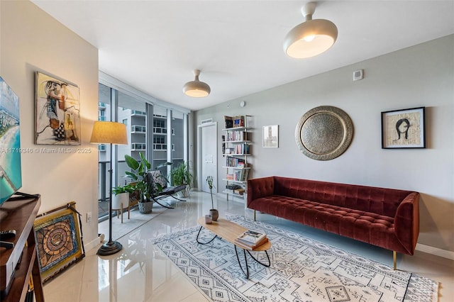 living room with floor to ceiling windows, light tile patterned floors, and a wealth of natural light