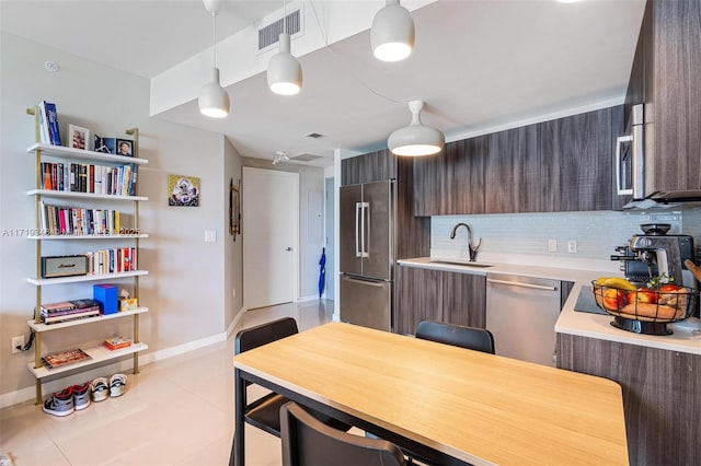 kitchen featuring pendant lighting, dark brown cabinets, and stainless steel appliances