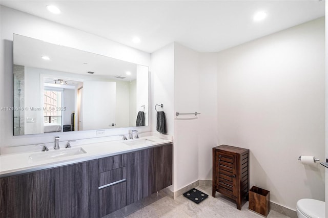 bathroom featuring vanity and toilet