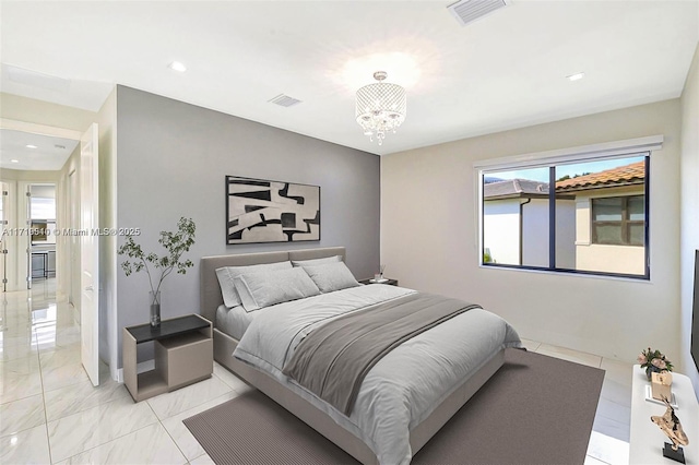 bedroom featuring a notable chandelier