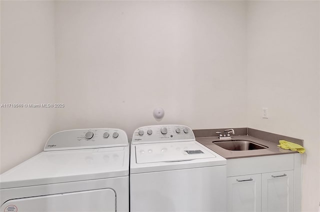 clothes washing area featuring cabinets, independent washer and dryer, and sink