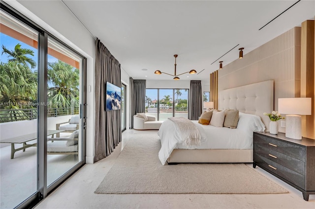 bedroom with access to exterior, multiple windows, and an inviting chandelier