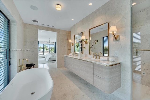 bathroom with vanity and a tub to relax in