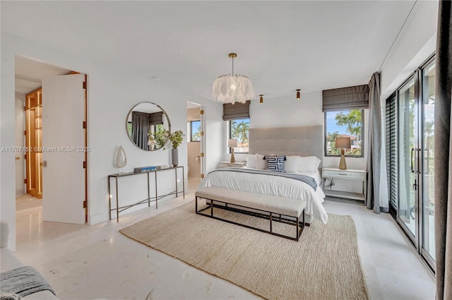 bedroom featuring access to outside and an inviting chandelier