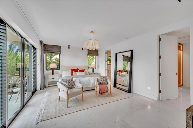 bedroom with access to outside and an inviting chandelier