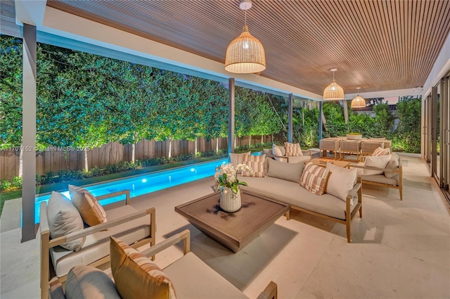 view of patio / terrace featuring an outdoor hangout area and a fenced in pool