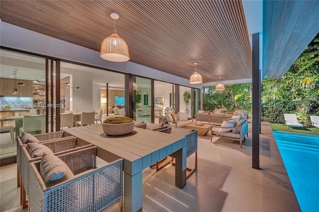 view of patio / terrace with outdoor lounge area and a pool