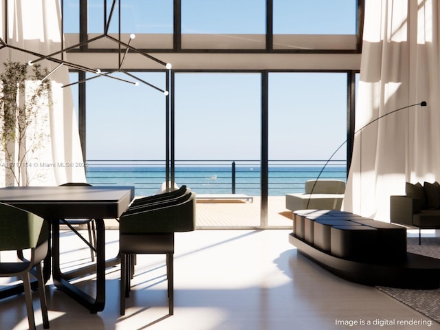 sunroom / solarium featuring a water view