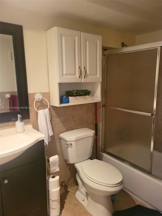 full bathroom with tile patterned floors, vanity, toilet, and combined bath / shower with glass door