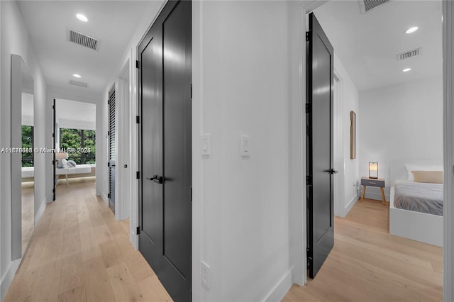 corridor with light hardwood / wood-style floors