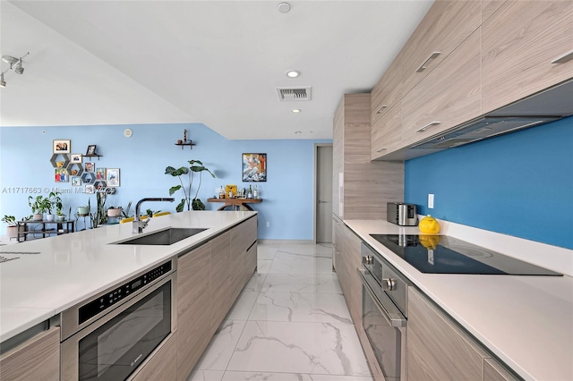 kitchen featuring exhaust hood, oven, sink, black electric cooktop, and light brown cabinetry