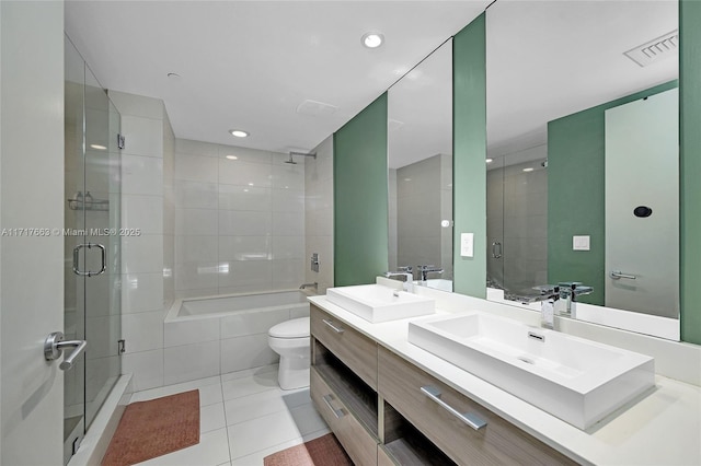 bathroom with tile patterned flooring, vanity, an enclosed shower, and toilet