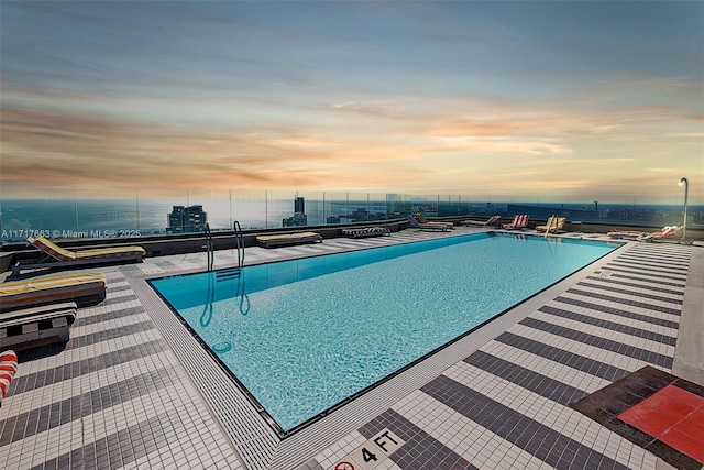 view of pool at dusk