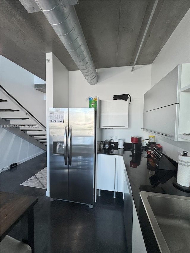 kitchen with white cabinets, stainless steel fridge, dishwasher, and sink