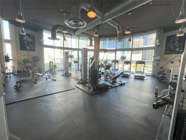 exercise room with a towering ceiling