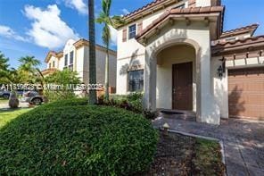 mediterranean / spanish home featuring a garage