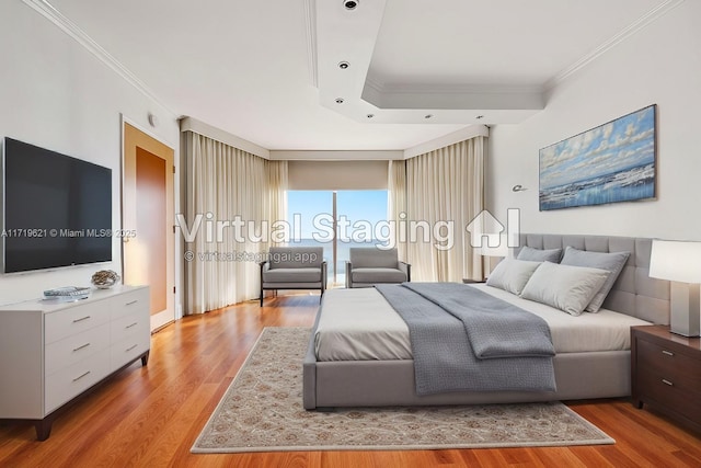 bedroom featuring ornamental molding and light hardwood / wood-style flooring