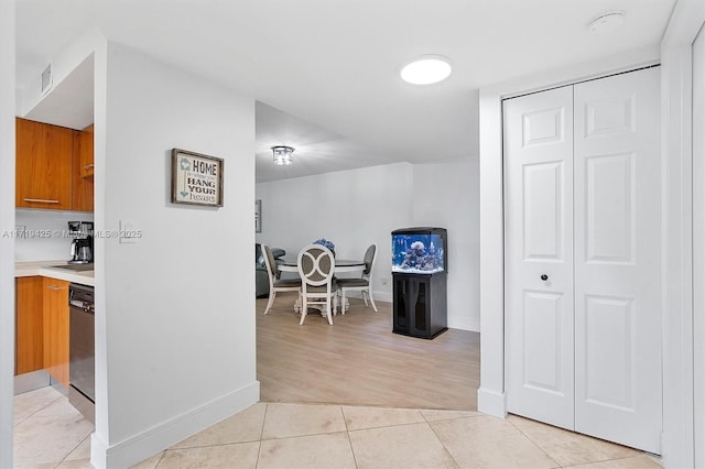 hall featuring light tile patterned flooring