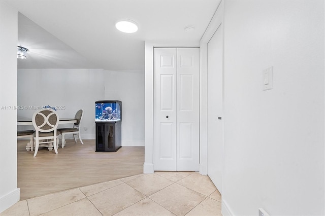 hallway with light tile patterned flooring