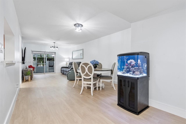 dining room with an inviting chandelier and light hardwood / wood-style flooring