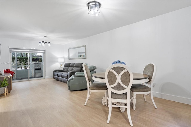 dining space featuring a chandelier and light hardwood / wood-style floors