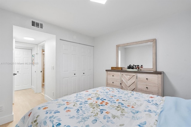 bedroom featuring a closet and light wood-type flooring