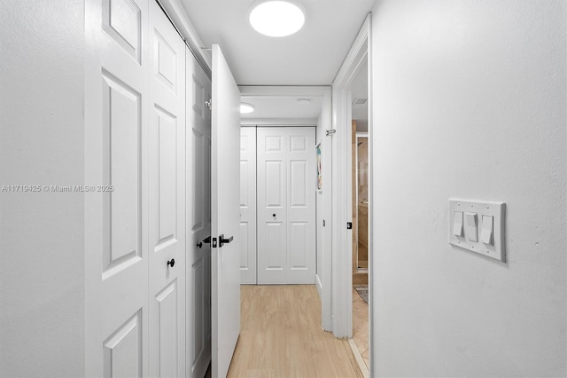 hallway with light hardwood / wood-style flooring