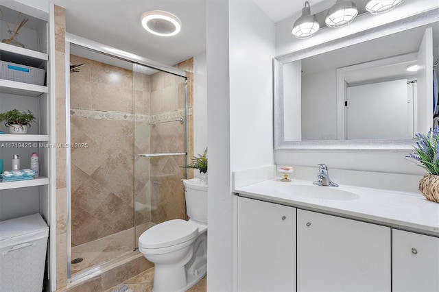 bathroom featuring vanity, toilet, and an enclosed shower