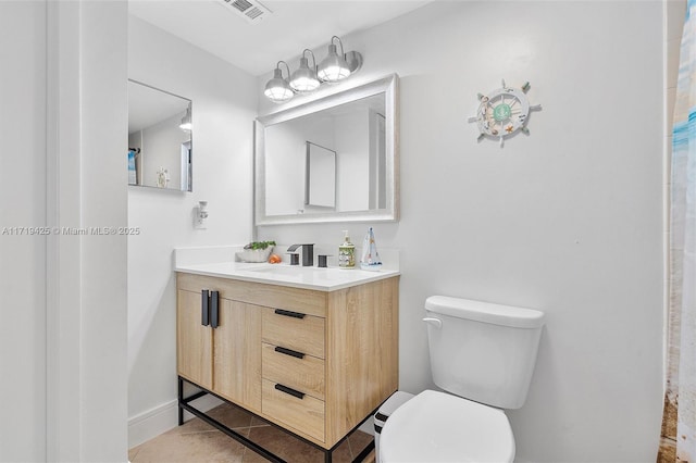 bathroom featuring tile patterned floors, vanity, and toilet