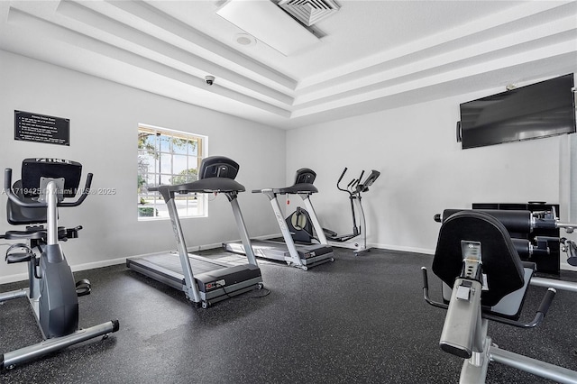 workout area featuring a tray ceiling