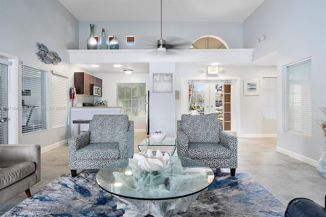 living room with ceiling fan, light wood-type flooring, and french doors