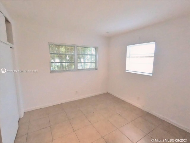 unfurnished room featuring light tile patterned floors