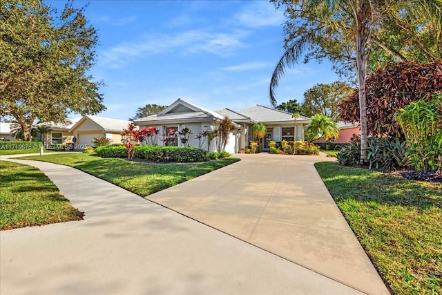 view of front facade with a garage and a front yard