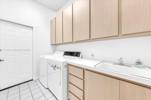 washroom with cabinets, washing machine and dryer, sink, and light tile patterned flooring