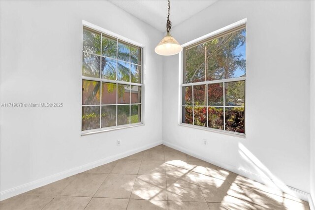 unfurnished dining area with light tile patterned floors