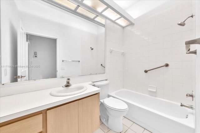 full bathroom with tile patterned floors, vanity, tiled shower / bath combo, and toilet