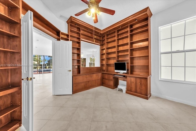 unfurnished office featuring ceiling fan