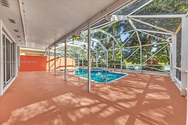 view of pool featuring an in ground hot tub, a patio area, and a lanai