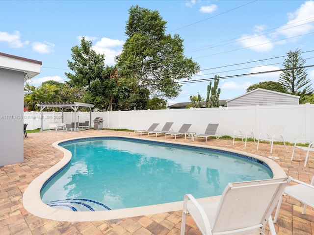 view of swimming pool featuring a pergola and a patio