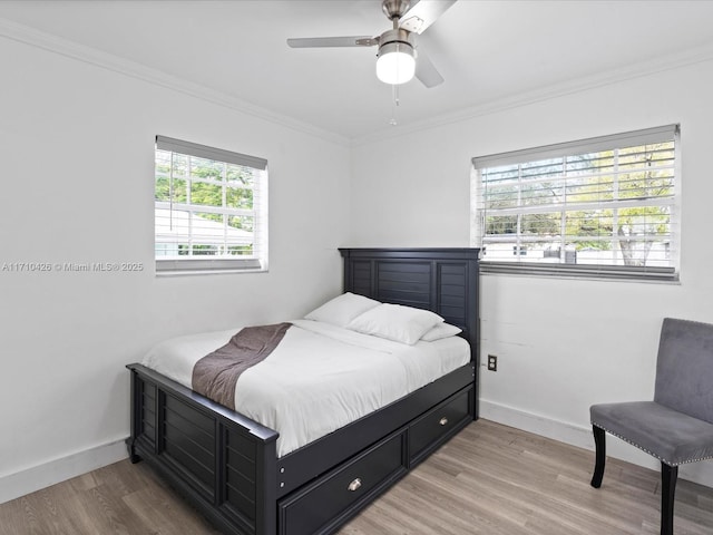 bedroom with crown molding, ceiling fan, and hardwood / wood-style floors