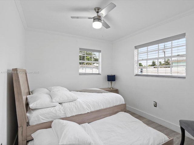 bedroom with crown molding, hardwood / wood-style floors, and ceiling fan