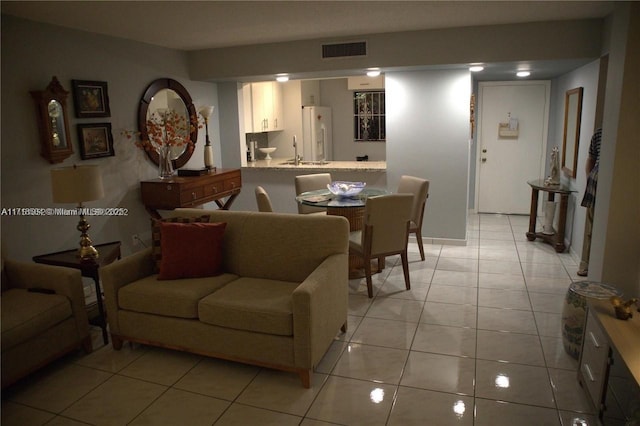 living room with sink and light tile patterned floors