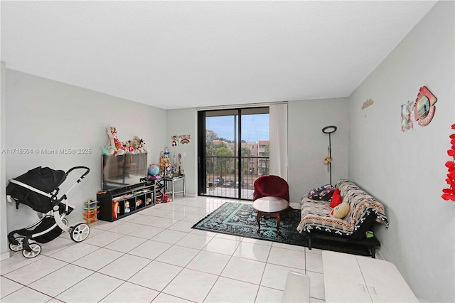 sitting room with a wall of windows and light tile patterned floors