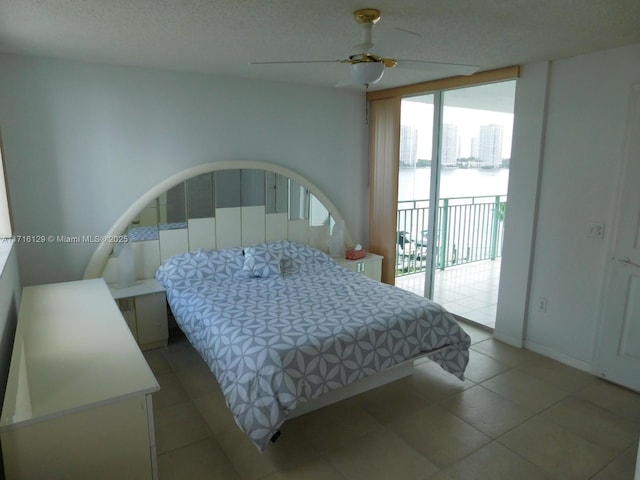 bedroom with ceiling fan, light tile patterned floors, and access to outside